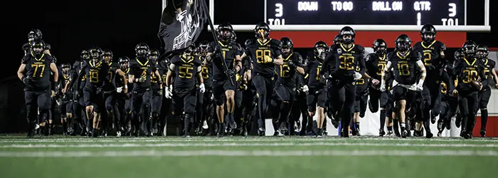 El Capitan Vaqueros Football hitting the field